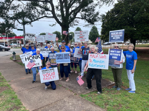 Indivisible GA-10 holding signs calling on Republicans to stop holding Georgia and the nation's economy hostage